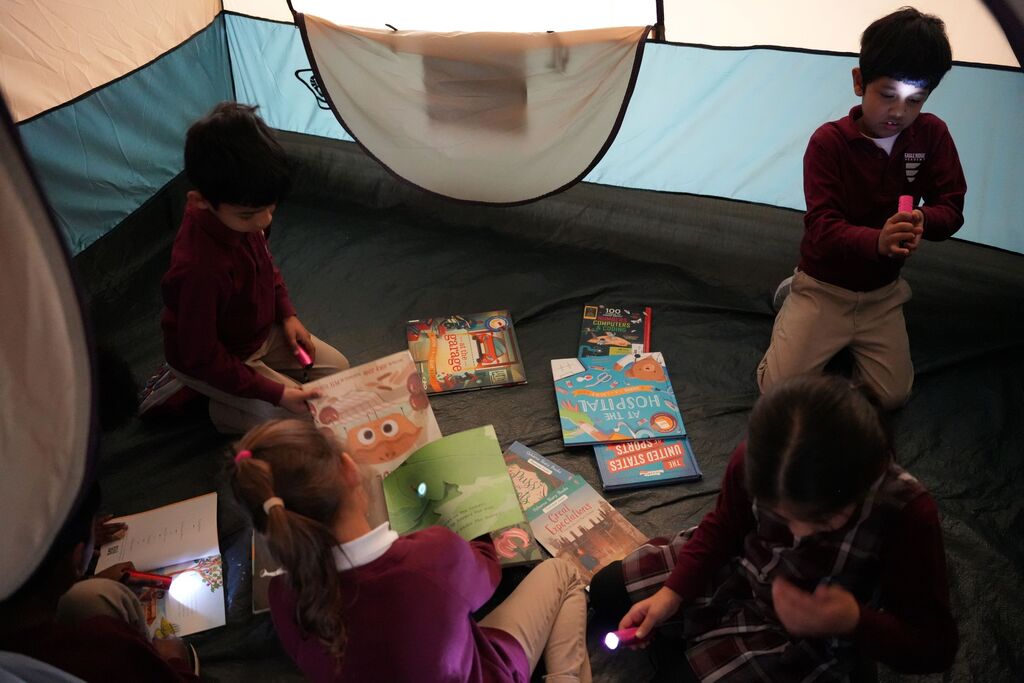 students reading in tent