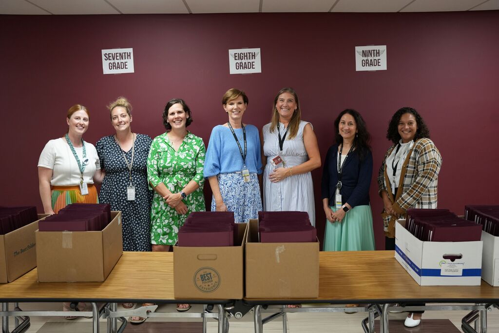 volunteers with folders