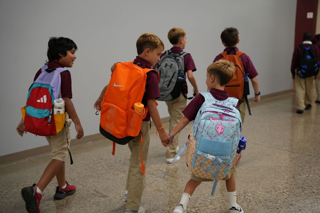 holding hands in hallway