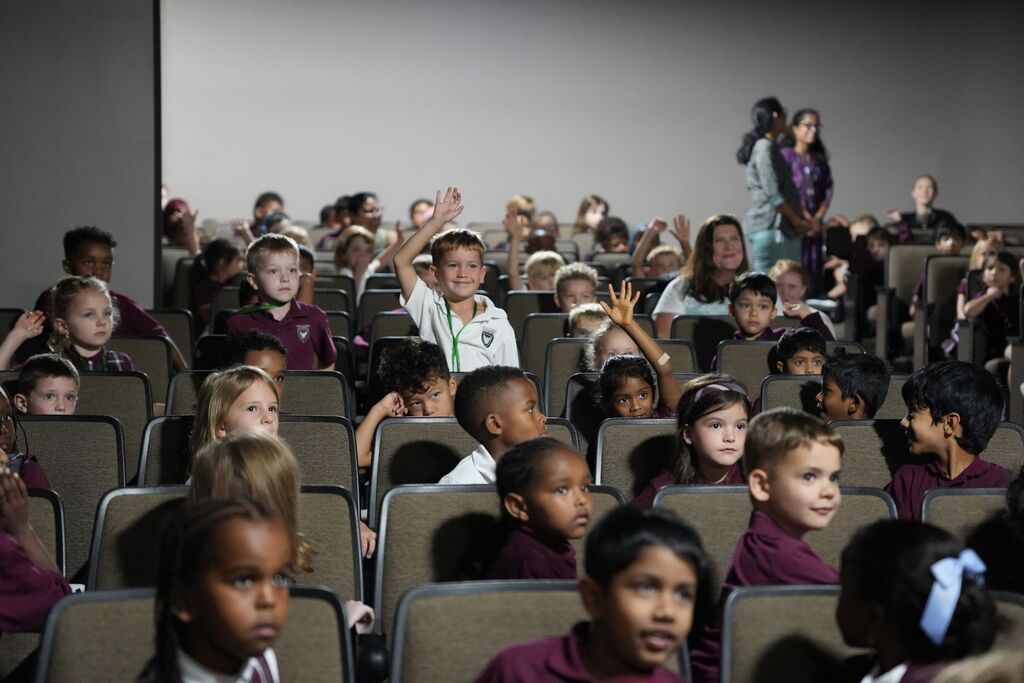 students raising hands