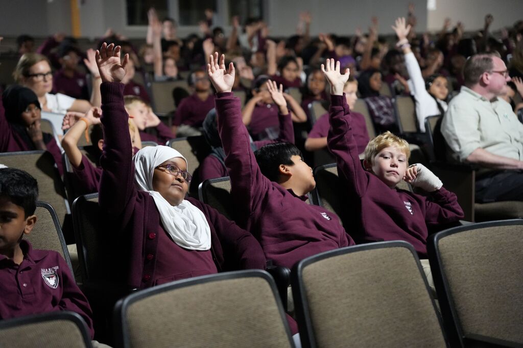 students raising hands