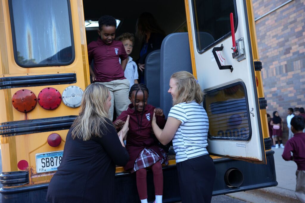 student smiling on bus