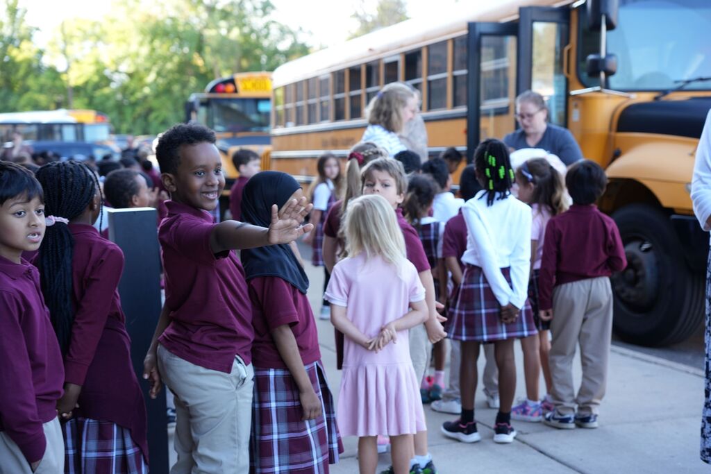 student waving