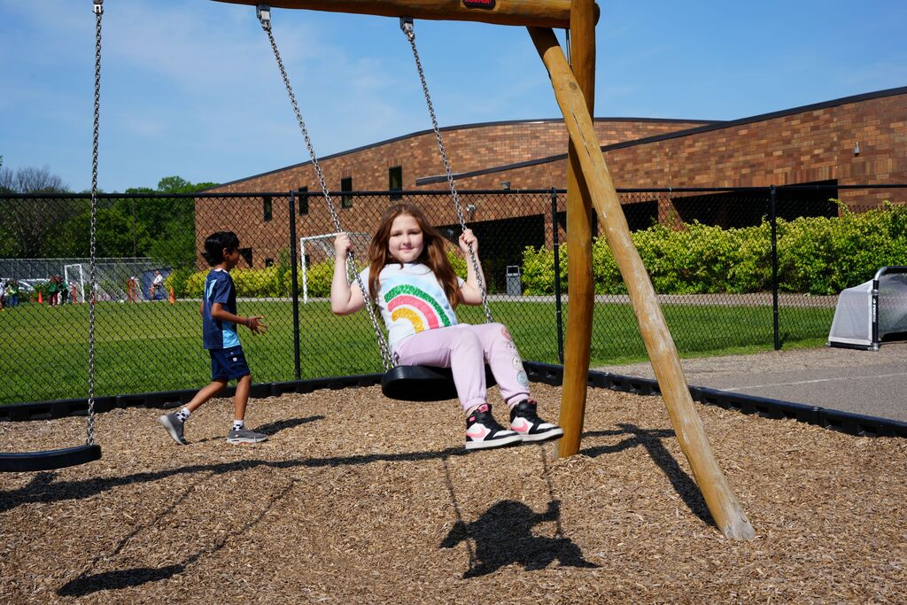 student on swings