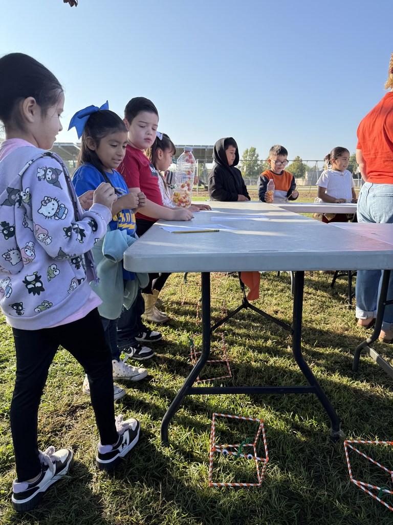 students flipping a water bottle with candy corn