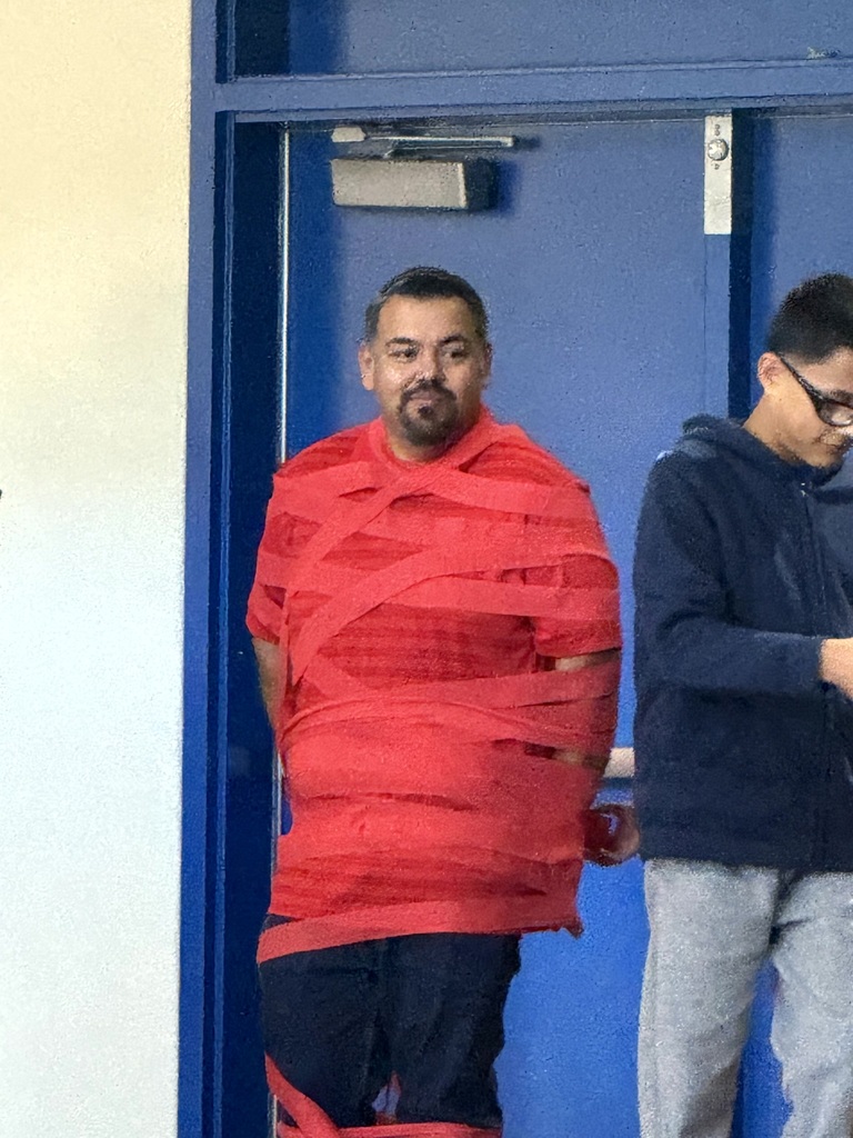 teacher wrapped in red string