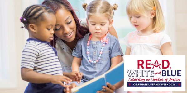 A teacher reads a book aloud to a small group of young children gathered closely around he