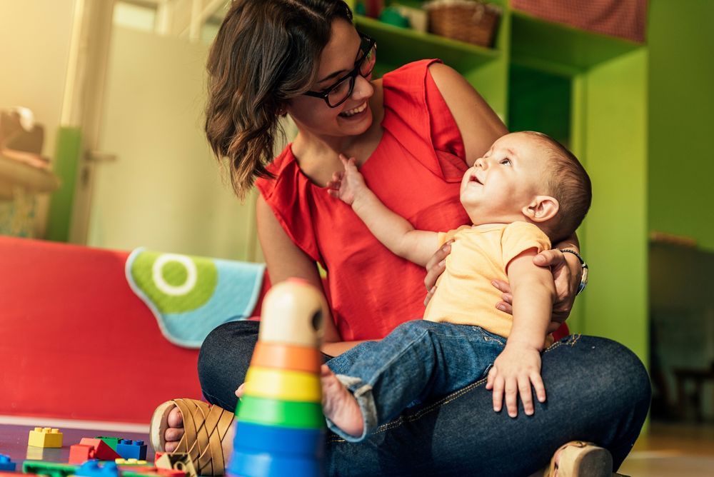 teacher playing with a baby
