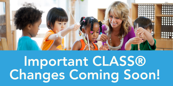 An adult sits at a table with several young children engaged in an arts-and-crafts activity inside a bright classroom