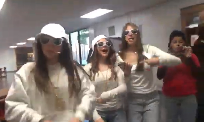 The picture shows a group of Heritage female students dressed up in white outfits on Halloween day at school.