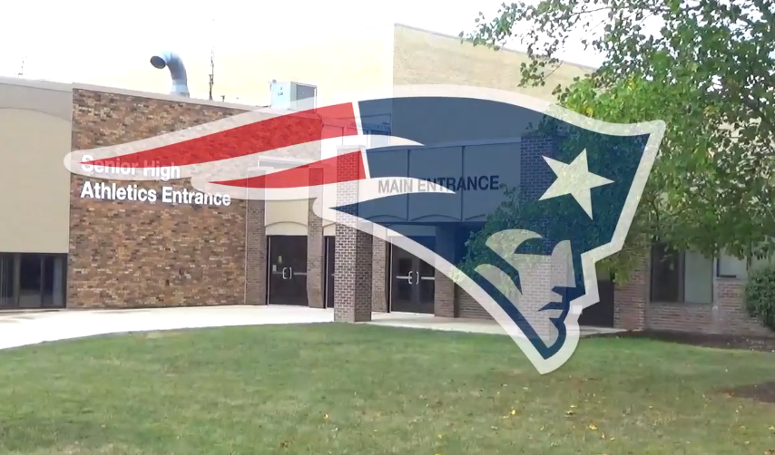 This image shows the outside of the main entrance of Heritage HIgh School, along with the Patriot logo.