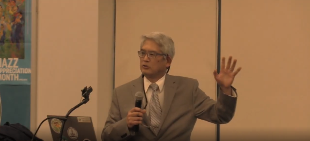 tsujimoto speaking at the podium