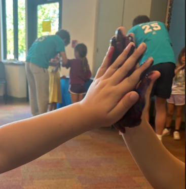 parkdale students high fiving with painted hands