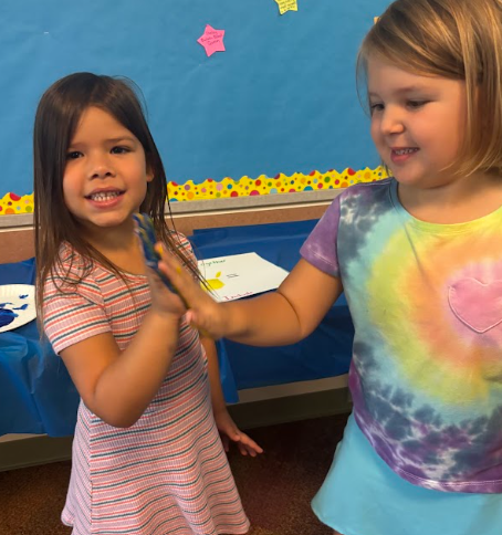 parkdale students high fiving with painted hands