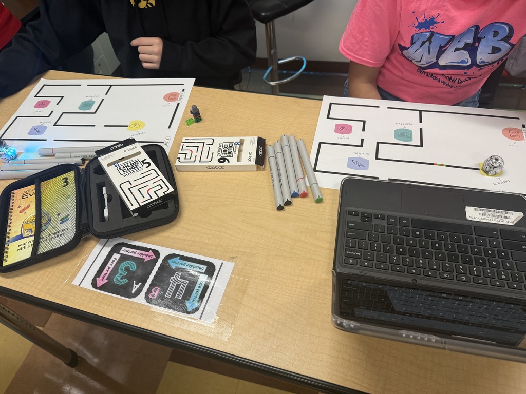students working on getting the ozobots to follow a set of instructions