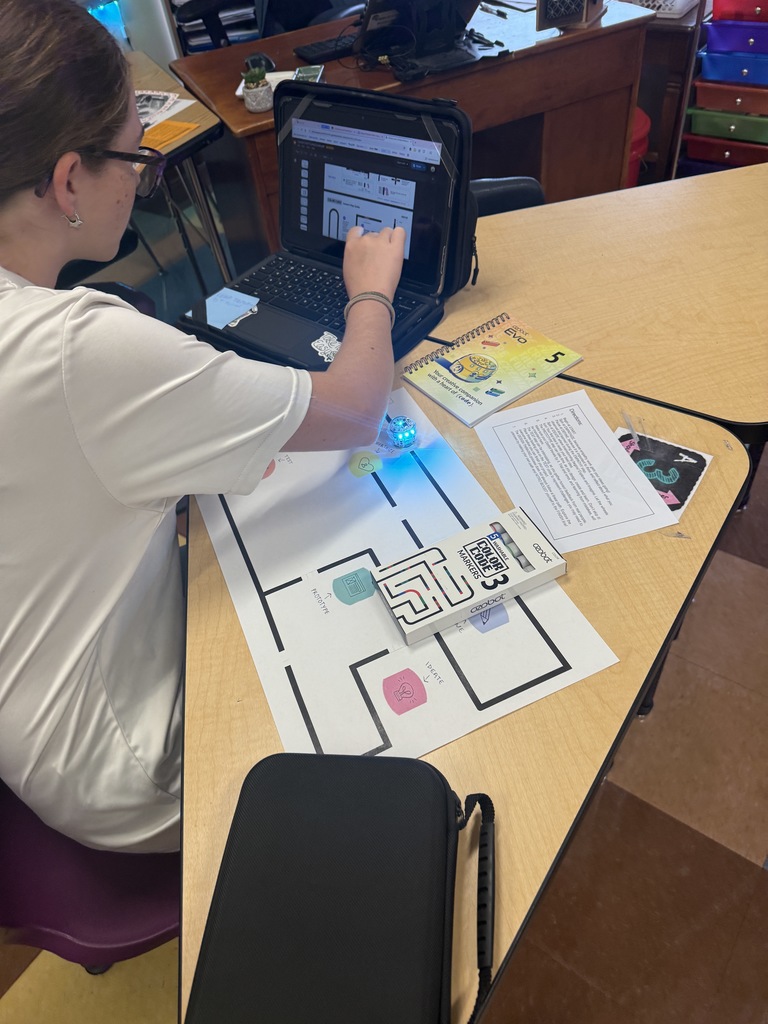 students working on getting the ozobots to follow a set of instructions