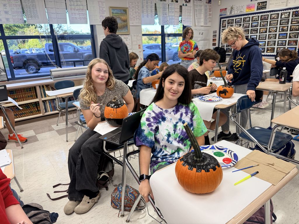 students designing pumpkins