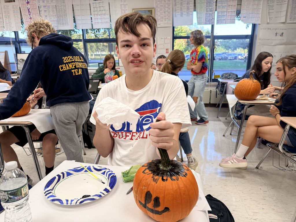students designing pumpkins