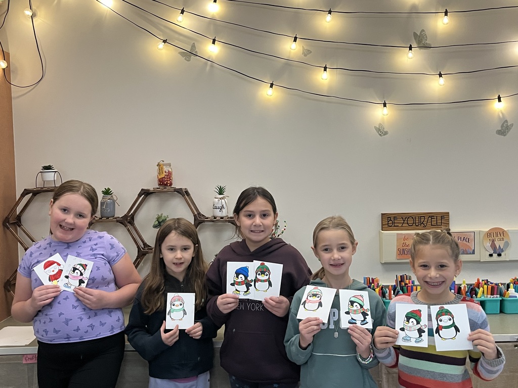 students holding christmas cards
