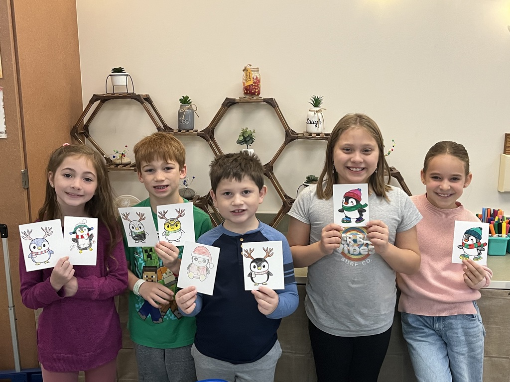 students holding christmas cards