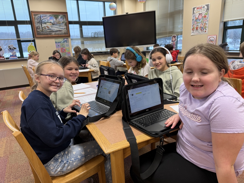 students writing a story on their Chromebooks