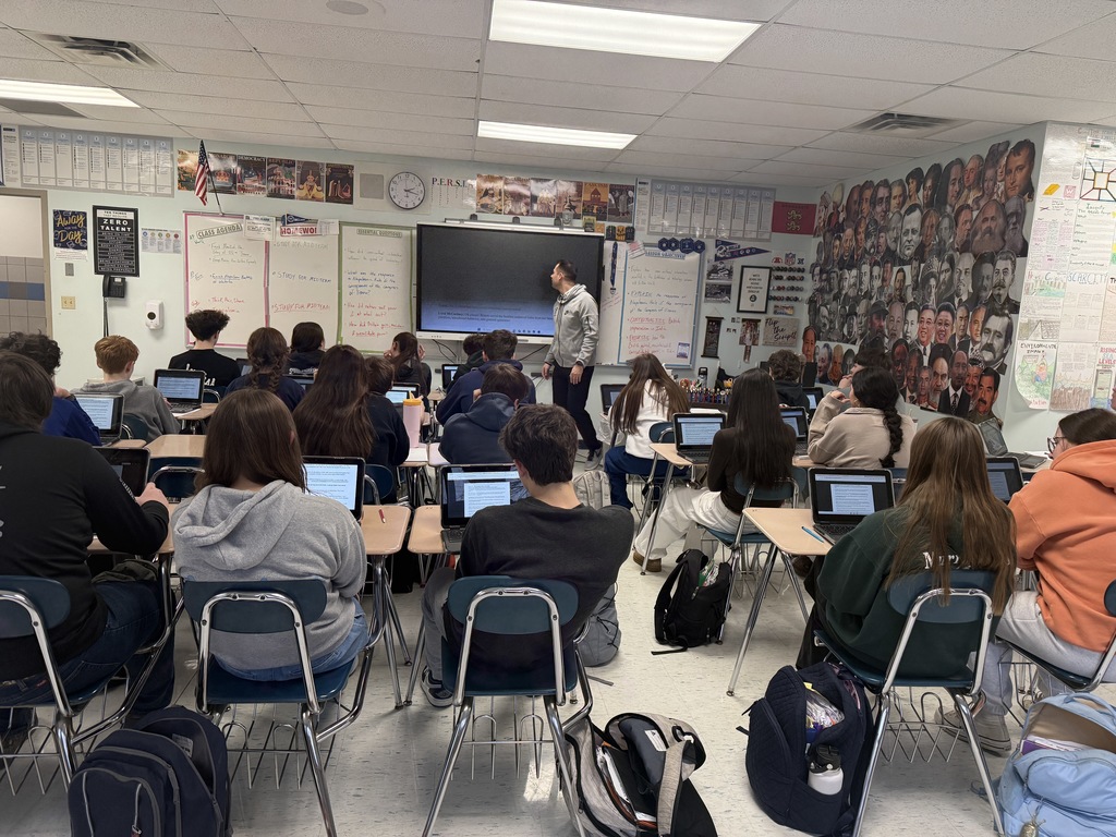 students seated in a classroom reading the story