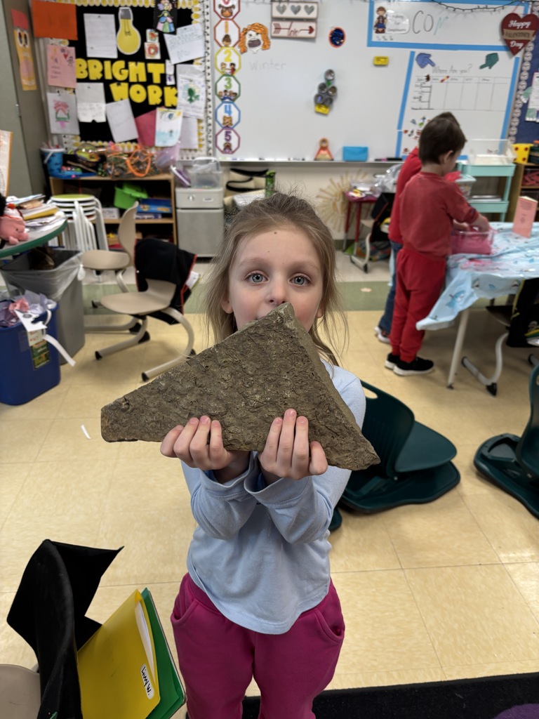student holding a rock