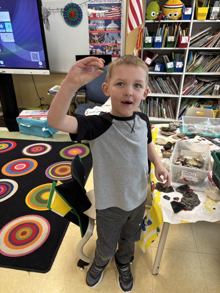 student holding rocks