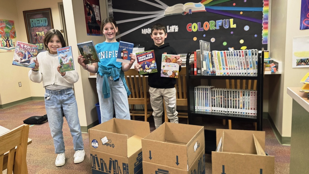 Three students holding books