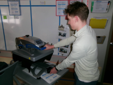 Student pressing a shirt for BDD