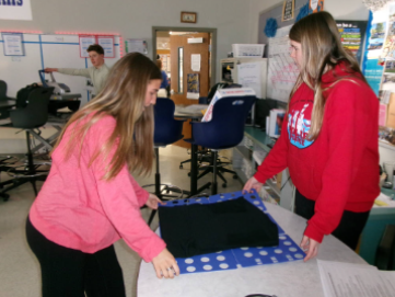 Student folding shirts for BDD