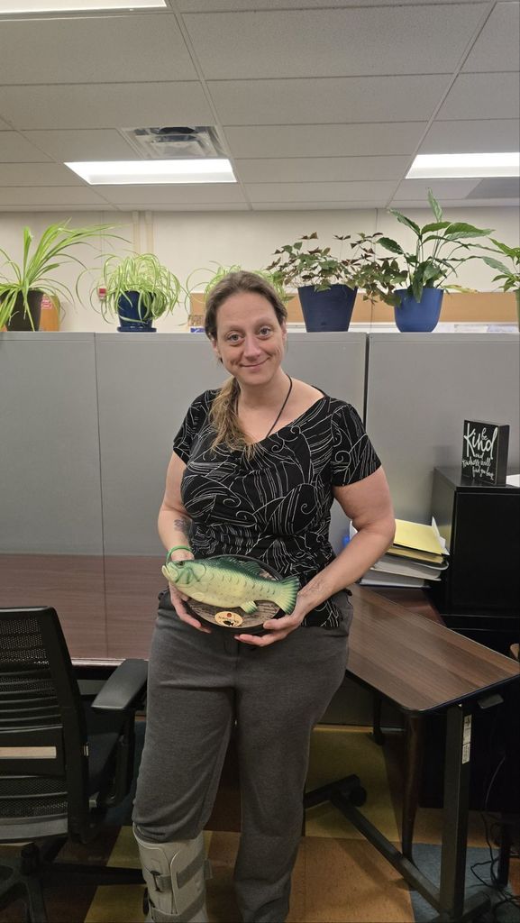 Beth Casey holding her Billy The Bass trophy, smiling proudly