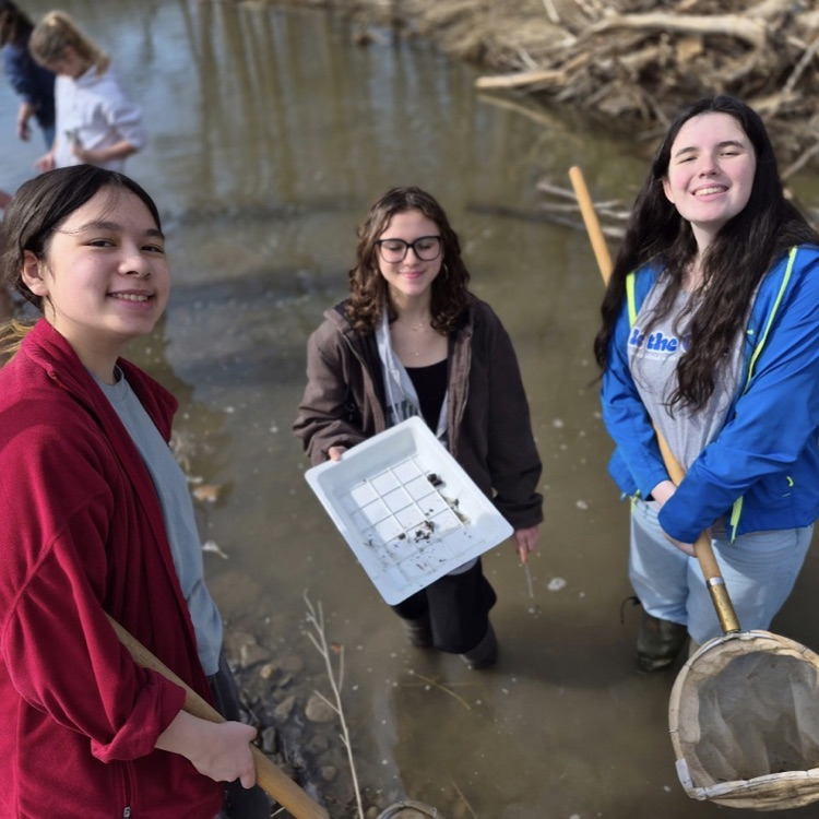 East Aurora students on a science club field trip cleaning the creek
