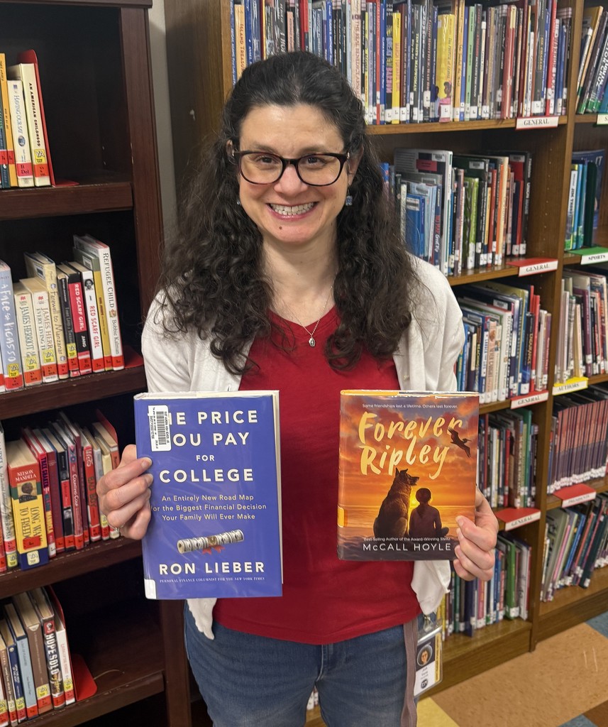 Mrs. Yorio holding her two books picks, The Price You Pay For College, and Forever Ripley