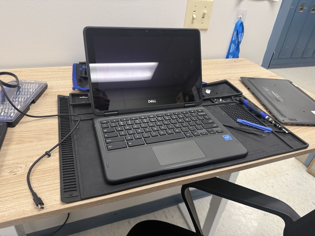 chromebook on the repair table surrounded by repair tools