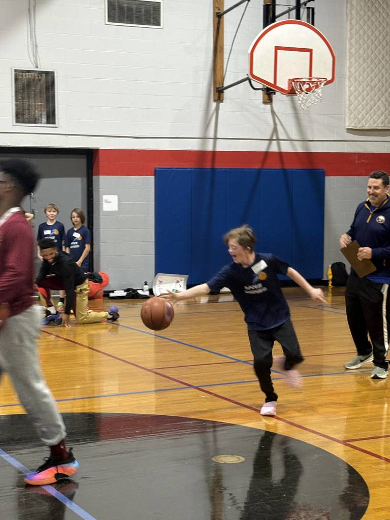 unified student dribbling the ball