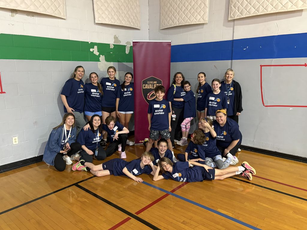 our unifed team posing with the Cleavland Cavaliers banner