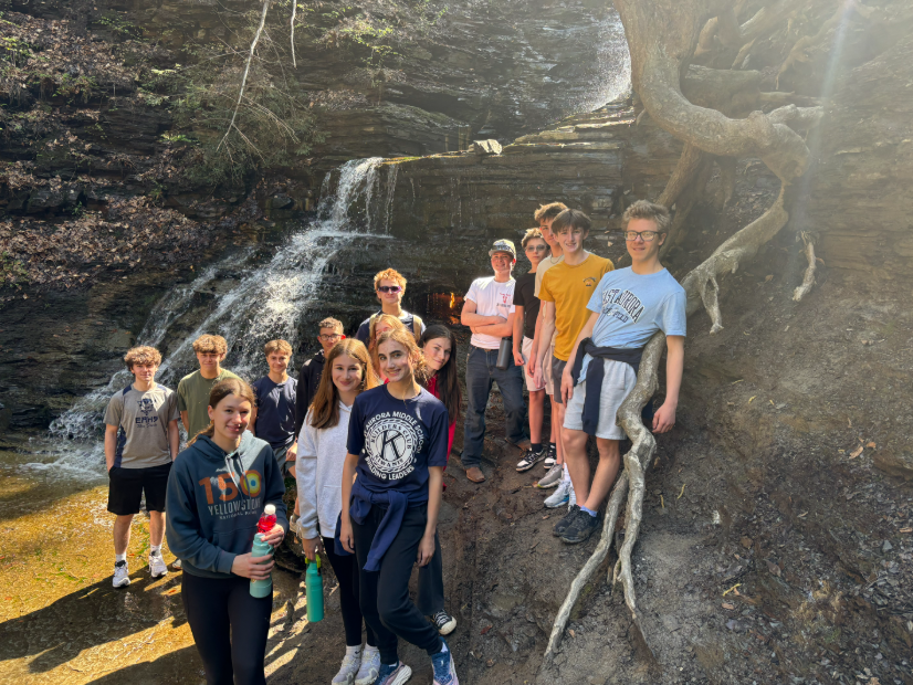 Adventure club students standing by the eternal flame
