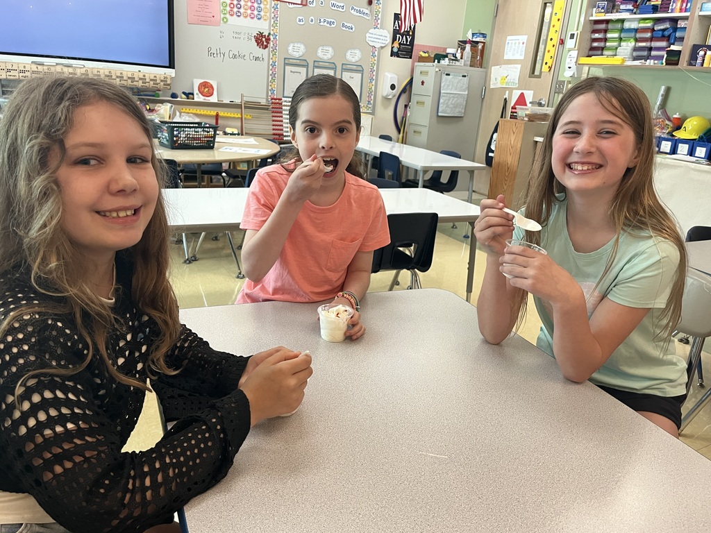 students smiling at a table eating ice cream