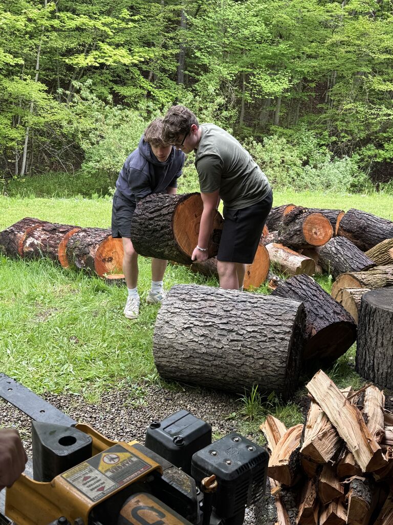 students completing service learning by chopping up wood