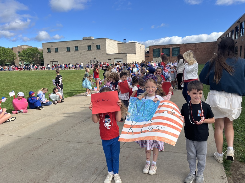 students holding their flag day poster