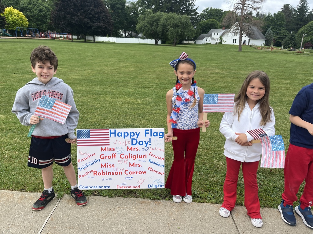 students holding their flag day poster