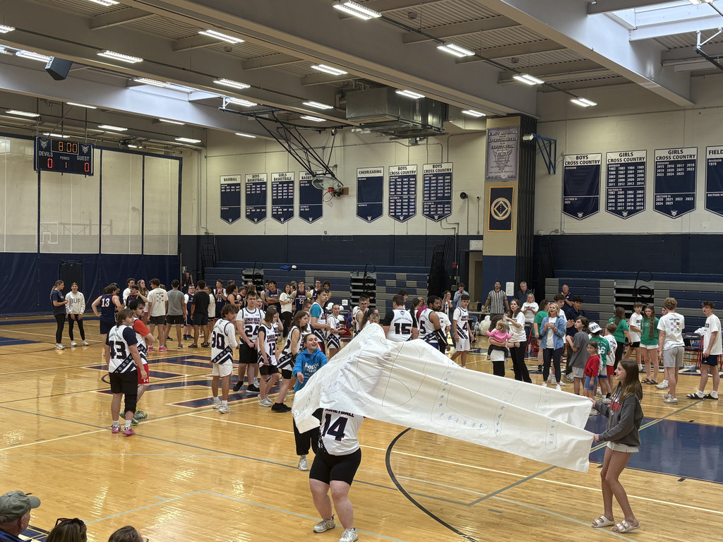 players running through the banner