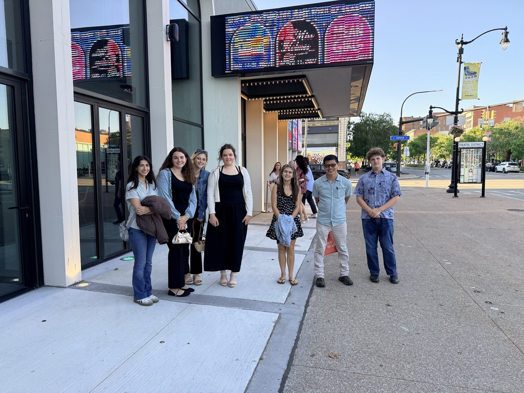students standing under the Sheas sign in Buffalo