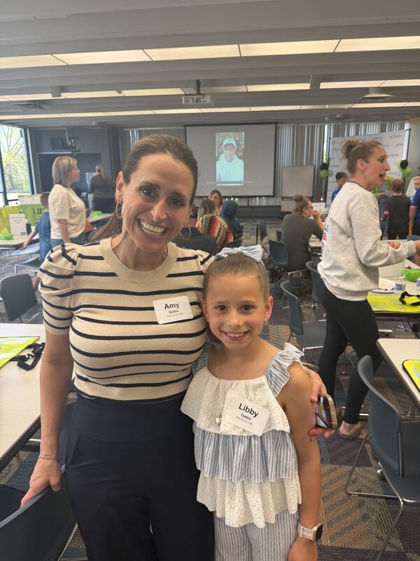 students and parent posing for a photo at the event