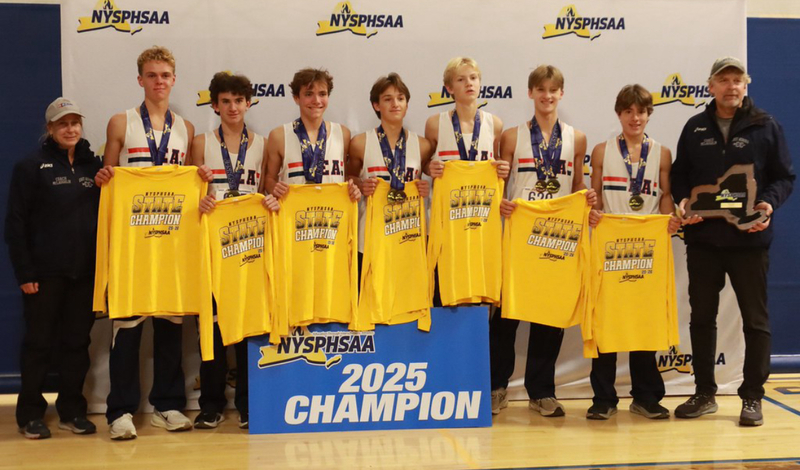 students posing for a picture with a 2025 chamption sign in front
