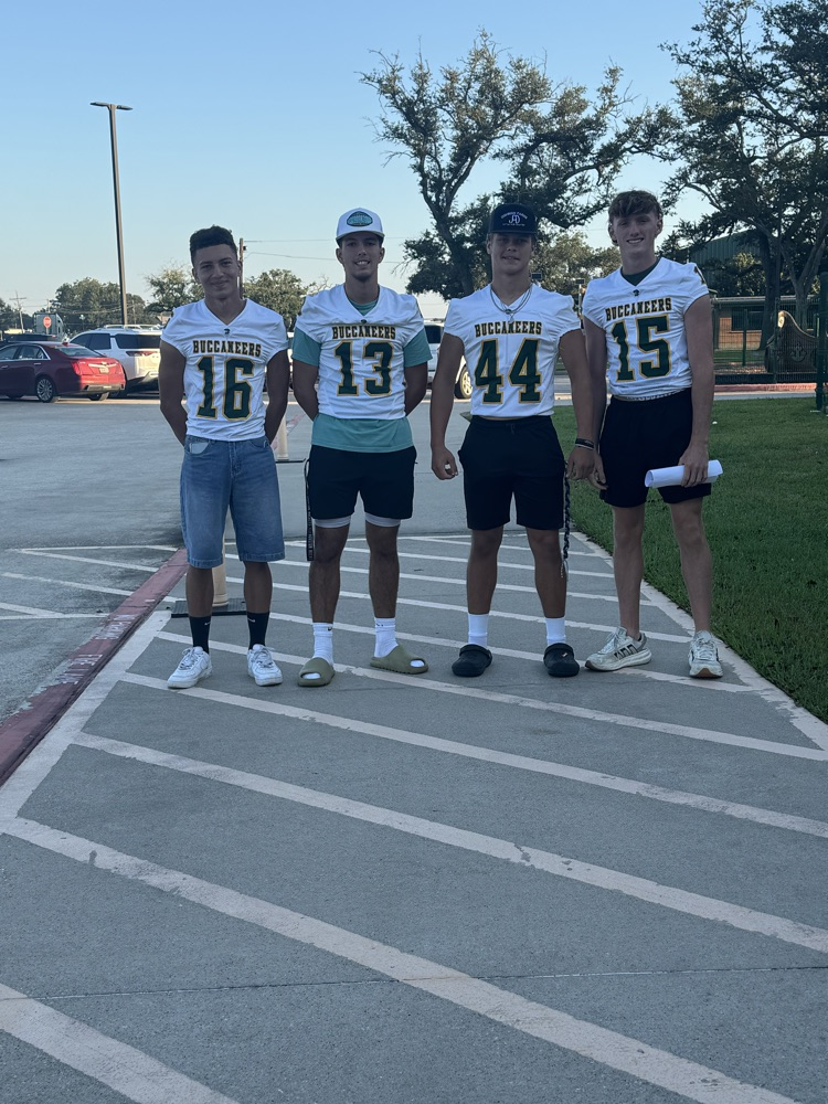 Varsity Football boys greeting our students