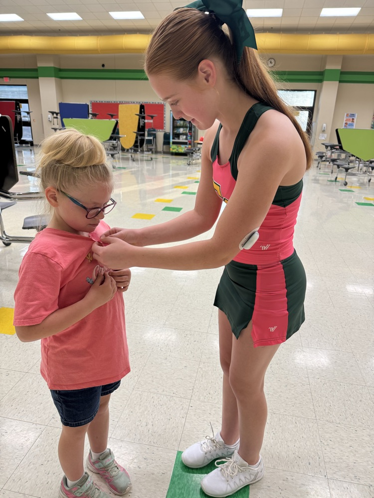 ECJH Cheerleader, Rainey Coffey helping a student