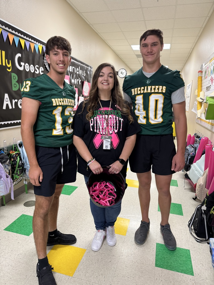 Mrs.Smith, 3rd Grade Teacher AND breast cancer survivor with her son and another football player
