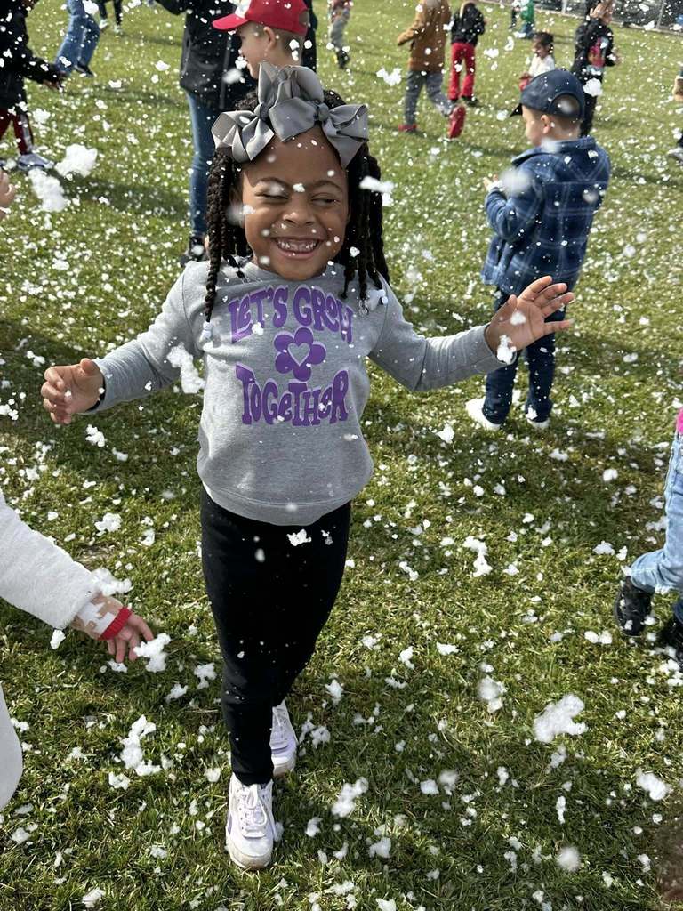 student playing in fake snow